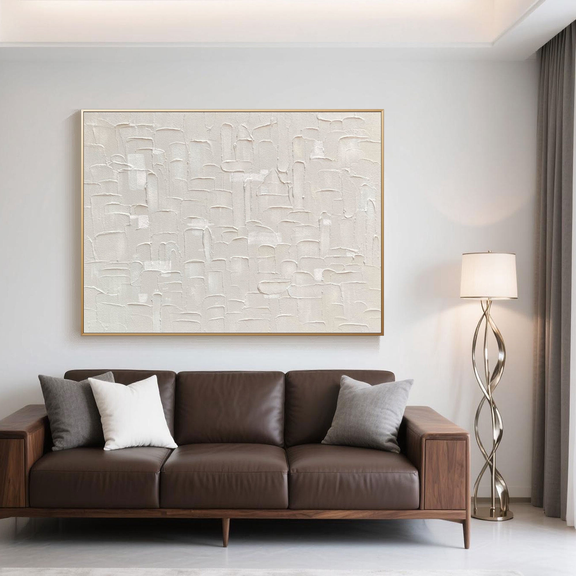 Minimalist art accenting a brown leather couch in a bright, modern room.