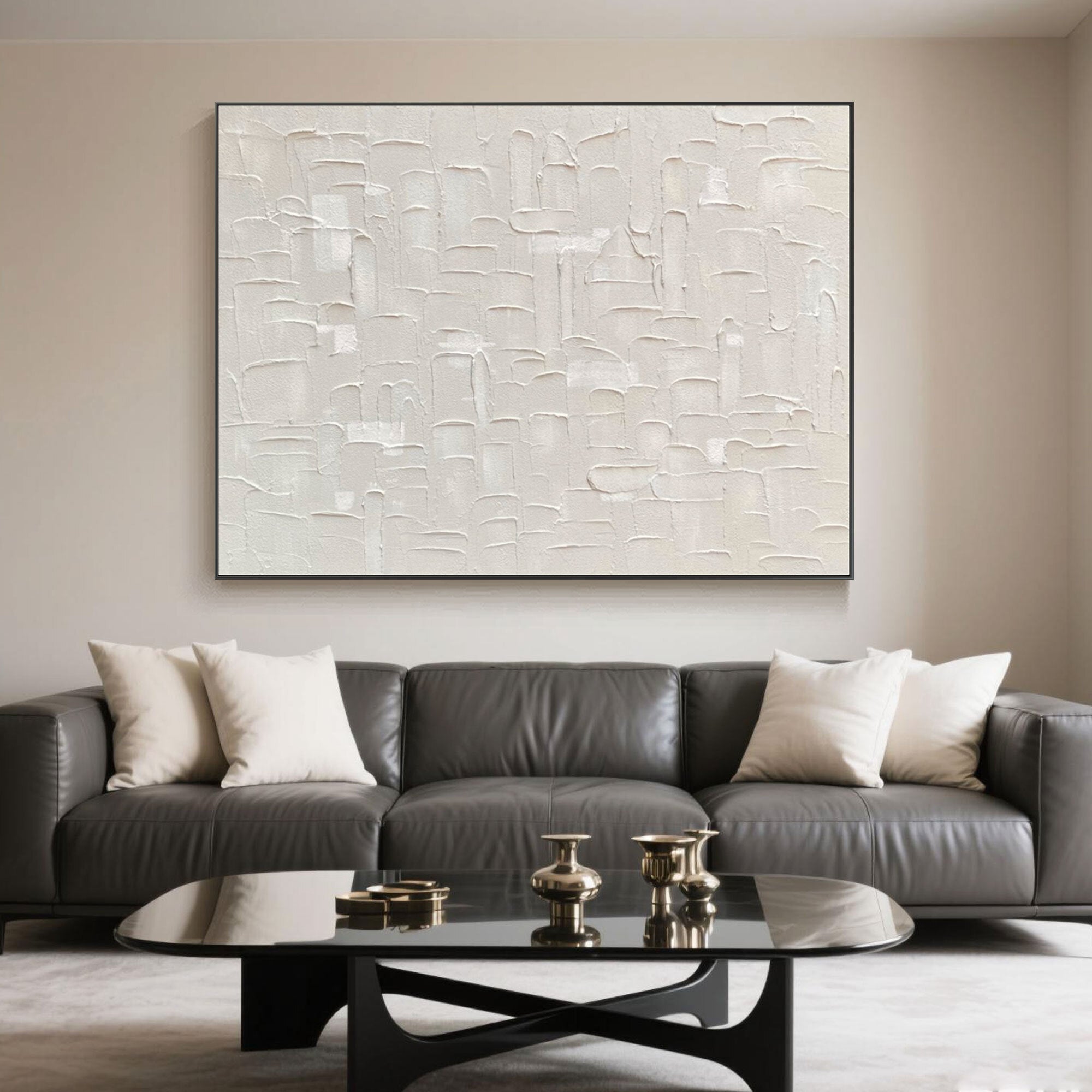 Beige canvas art mounted over a dark couch in a refined living area.