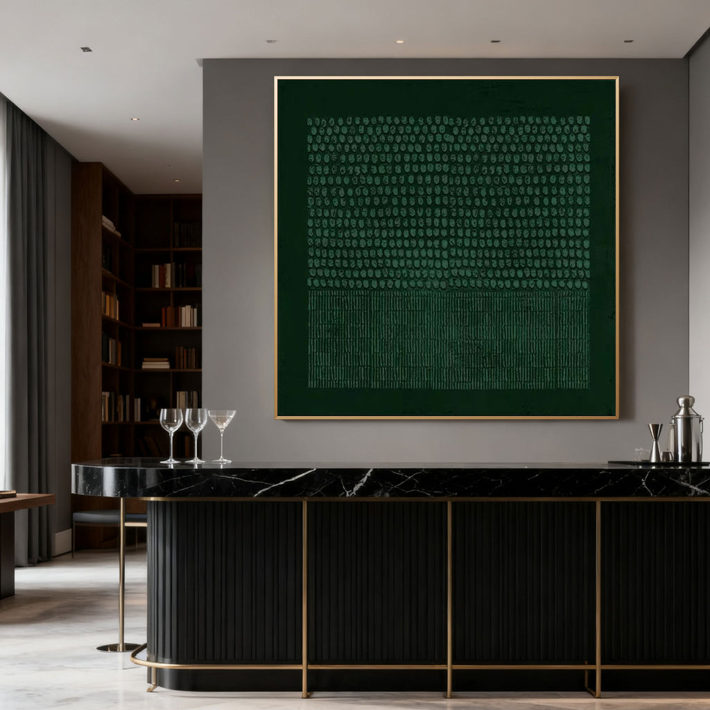 Authentic hand-painted Wabi-Sabi geometric textured painting in deep green with gold frame, showcasing textured circular and linear patterns, displayed in modern interior above black marble bar.
