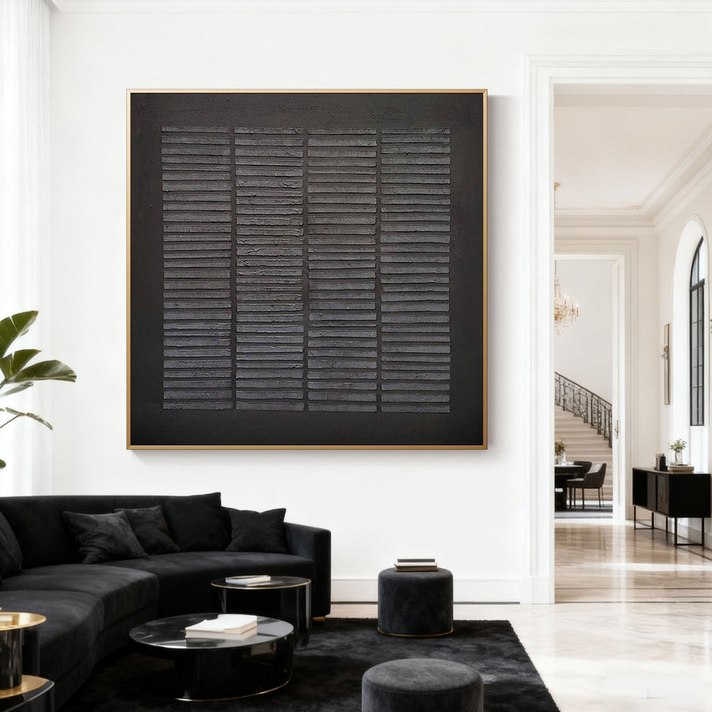 Black textured geometric wall art 'Weathered Grid' with gold frame in modern living room