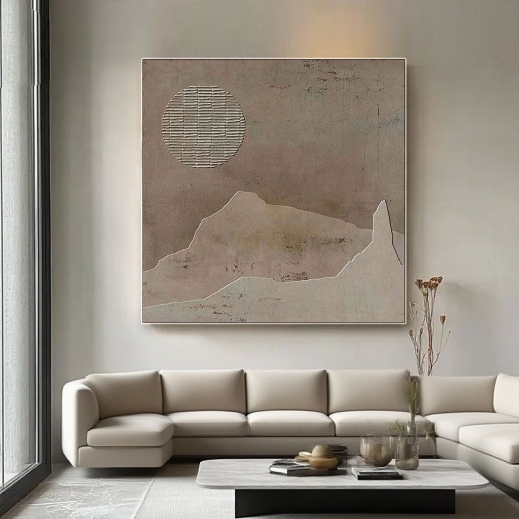Wabi-sabi landscape painting in living room. Brown tones, abstract sun and mountain shapes.