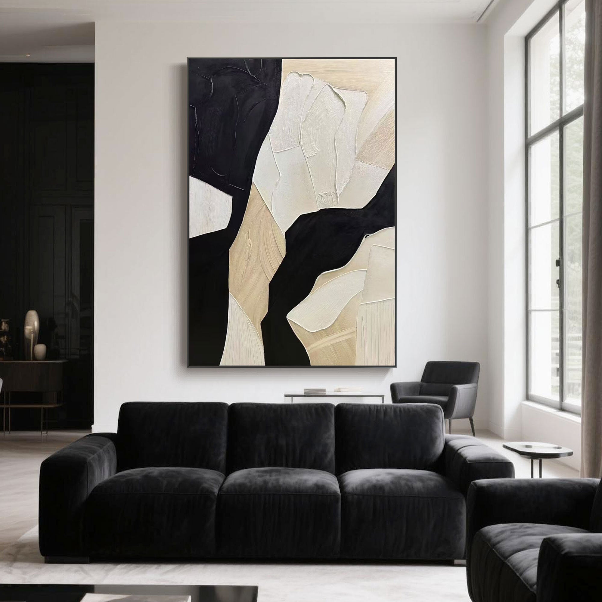 Beige and black abstract wall art adds bold contrast to a black sofa in a modern interior with tall windows and white walls.