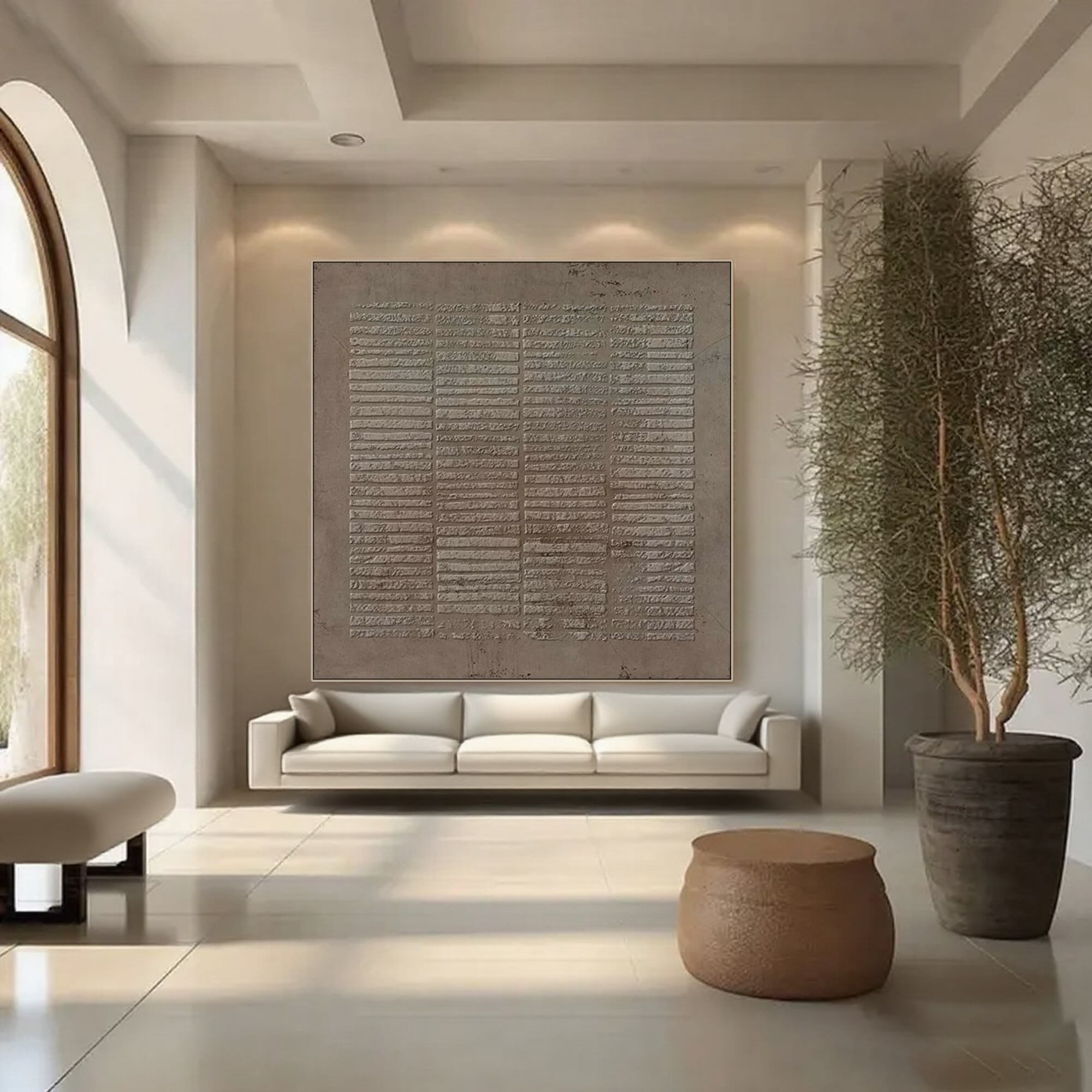 Wabi Sabi square canvas art in sediment color above a white sofa.