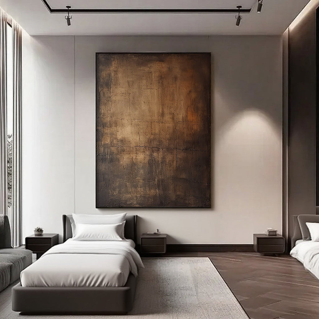 Wabi-Sabi Brown Abstract Wall Art 'Ancient Light' - Large hand-painted canvas with textured brown and gold tones, displayed in a modern bedroom with neutral walls and minimalist furniture.