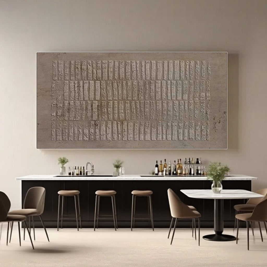 Wabi Sabi brown textured wall art in a dining area with a bar and stools.
