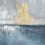 Close-up of blue gray abstract seascape art with raised texture and gold accents