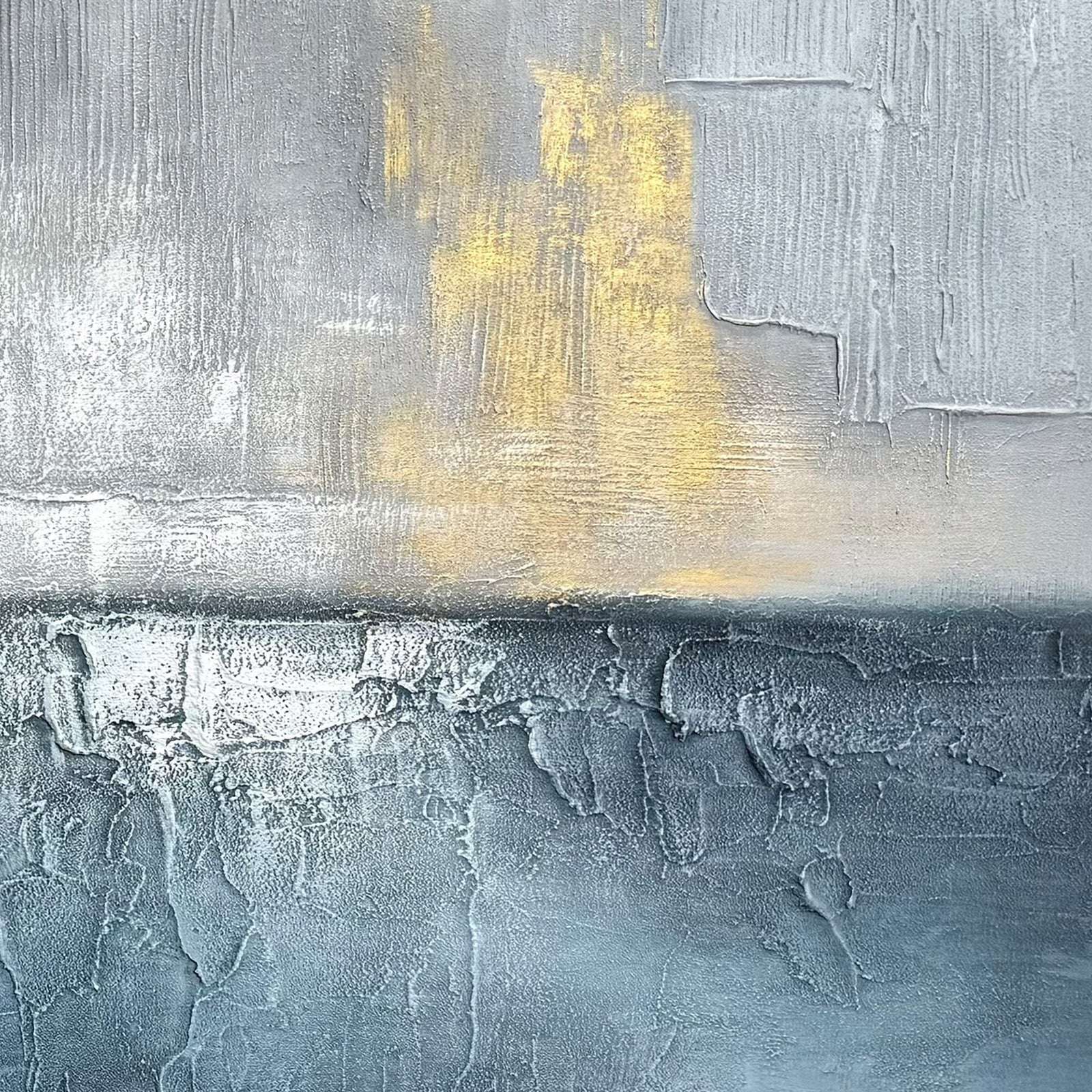 Close-up of blue gray abstract seascape art with raised texture and gold accents