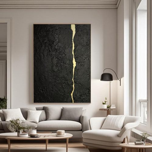 Abstract minimalist black and gold hand-painted canvas wall art with kintsugi vein, displayed in a modern living room.