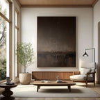 Abstract minimalist brown landscape painting 'Umber Dusk' with textured brushstrokes in umber and dark brown tones, displayed in a modern living room setting.