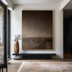 Abstract minimalist brown landscape painting 'Umber Dusk' on white wall with textured canvas