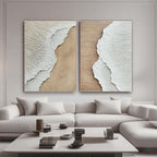 3D textured coastal wall art set above a neutral sofa in a modern living room