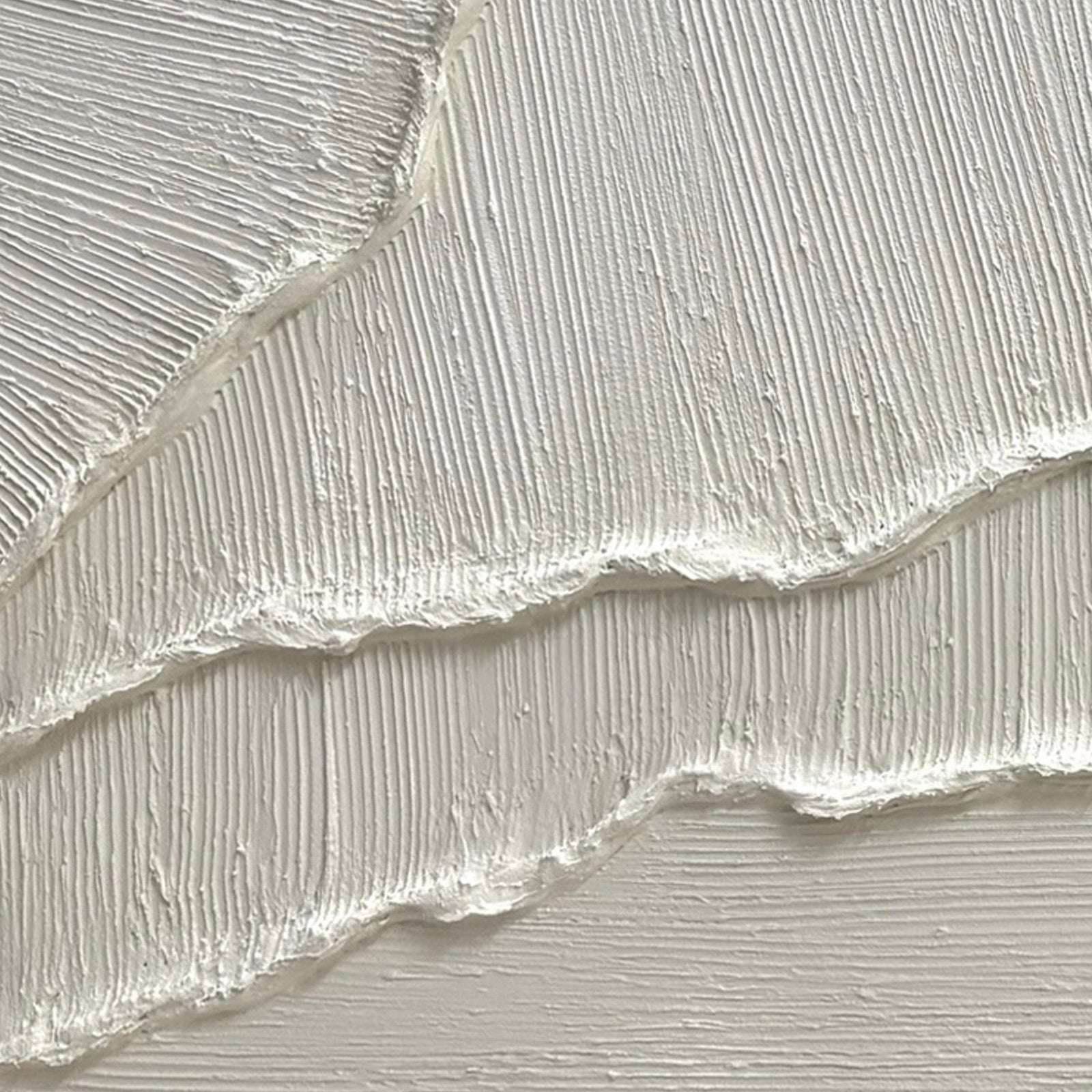 Detail of minimalist white 3D wall art with fine linear texture and raised relief