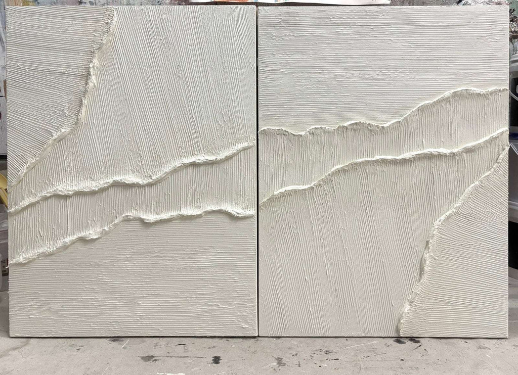 Close-up of white textured wall art with soft raised tide lines across two panels