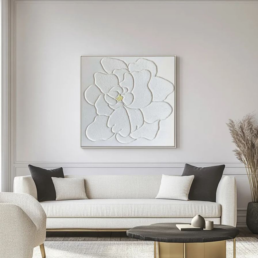 White floral plaster art hanging above a sofa in a living room setting.