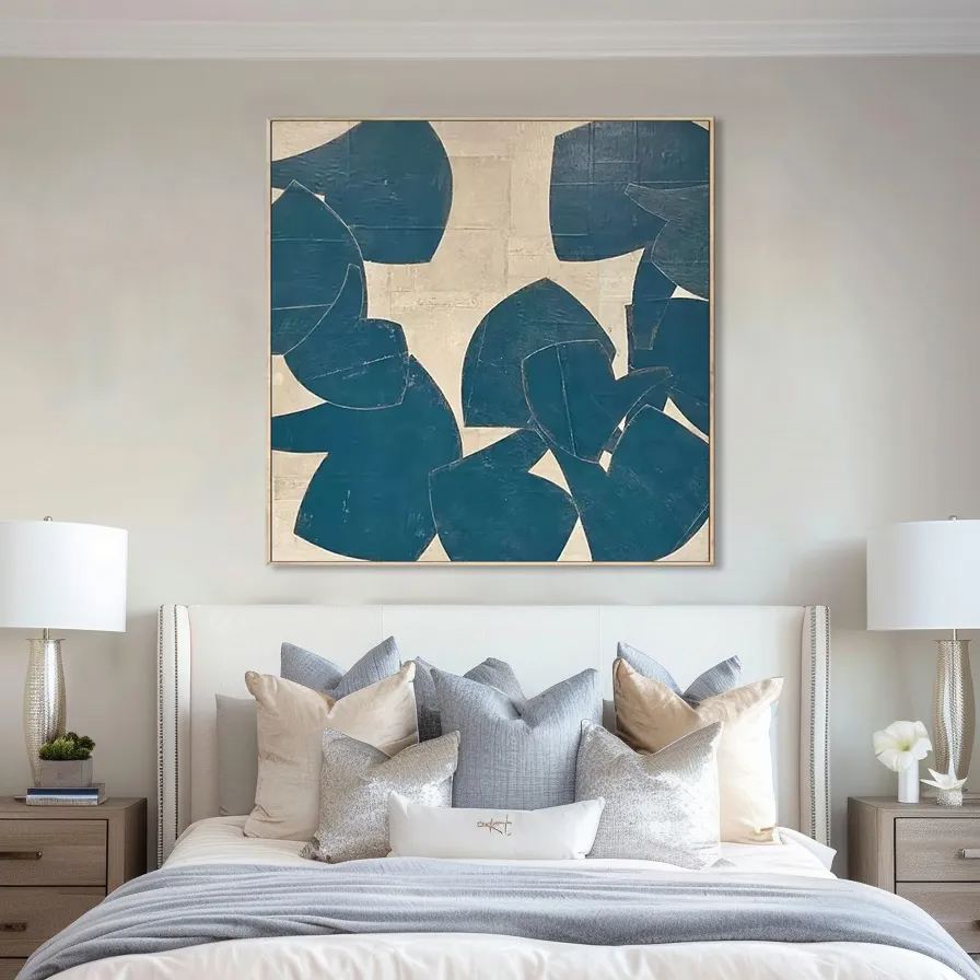 Teal and beige abstract painting above a bed in a styled bedroom.