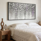 3D Textured Silver Floral Wall Art - Pewter Bloomfall featuring raised silver flowers with lavender accents in black frame above bed