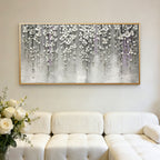 Silver floral 3D textured modern wall art with gold frame above white sofa at Lumi Gallery