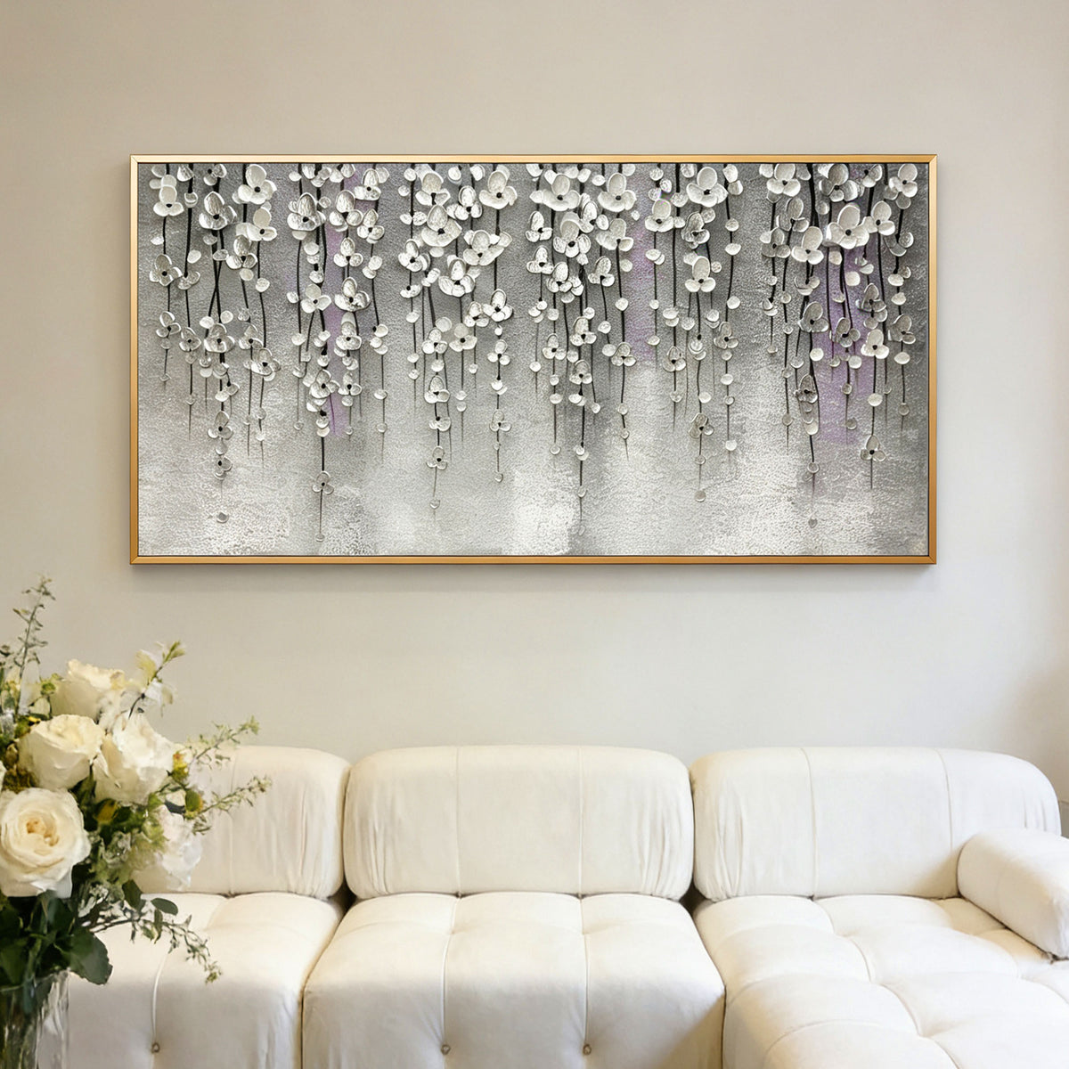 Silver floral 3D textured modern wall art with gold frame above white sofa at Lumi Gallery
